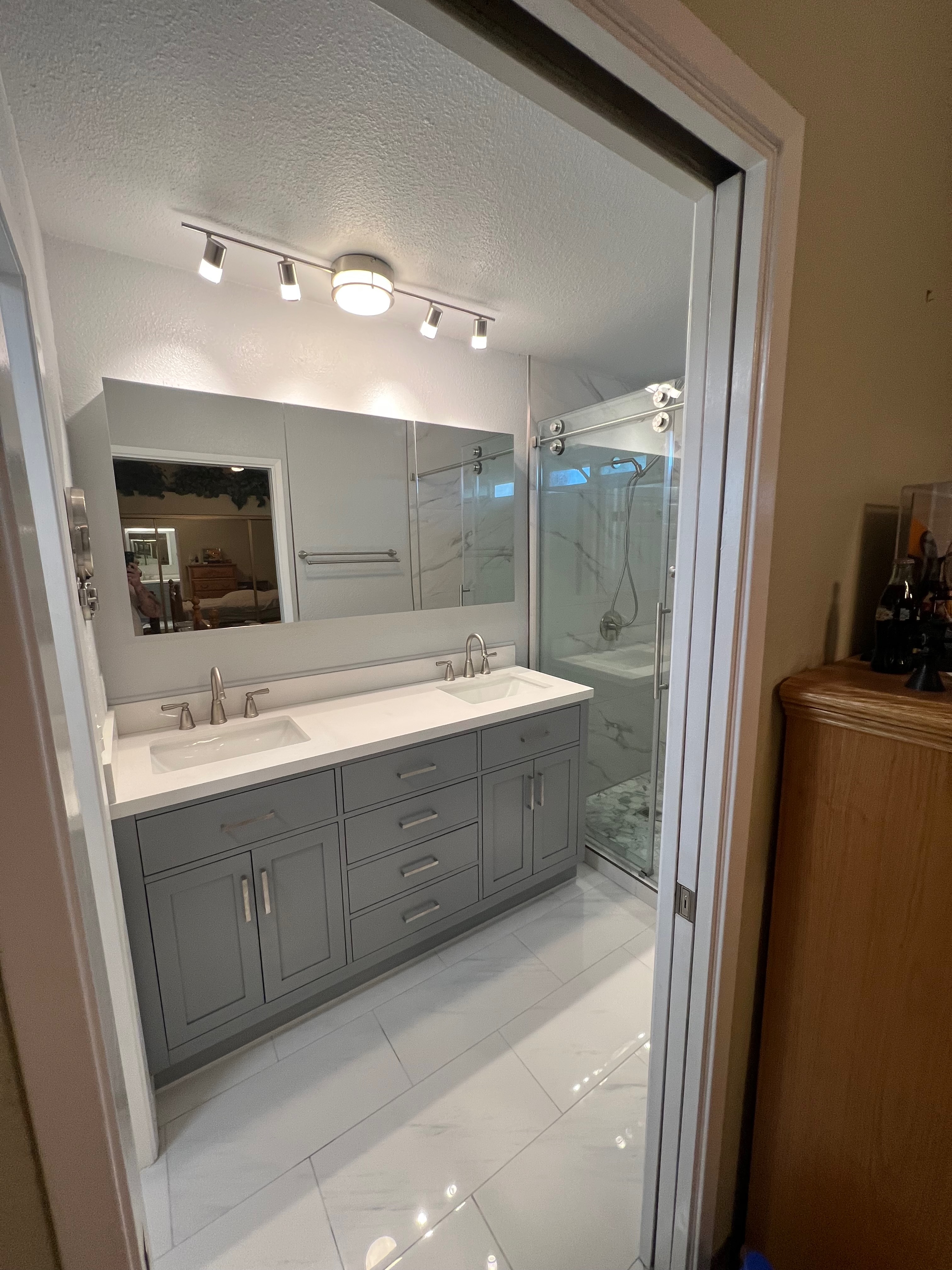 After photo of modern gray shaker double vanity with quartz countertop bathroom remodel Riverside CA