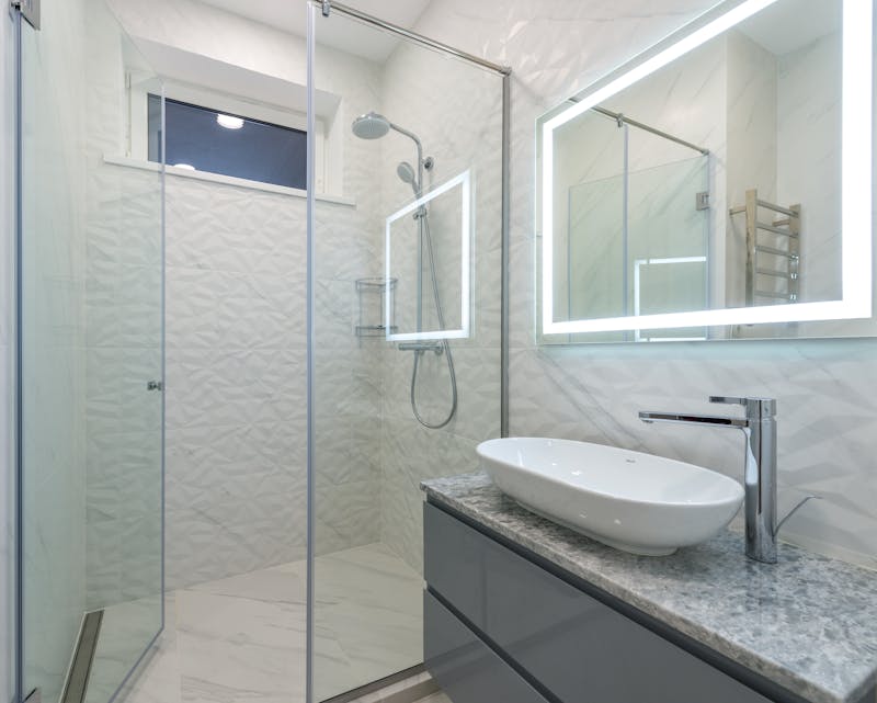 Modern glass shower with LED mirror and vessel sink bathroom renovation Riverside CA
