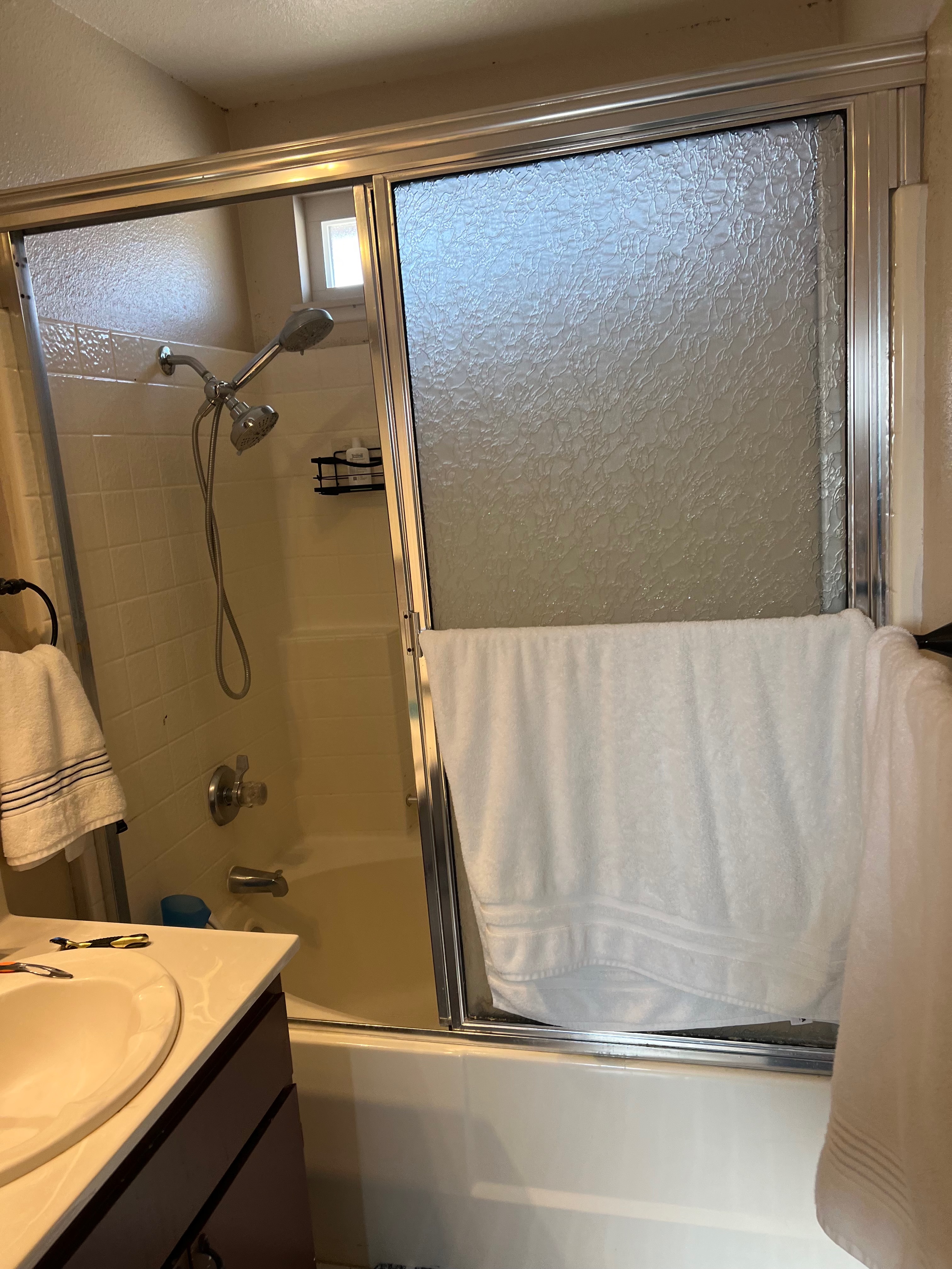 Before photo of outdated tub shower combo with frosted sliding glass doors Riverside CA
